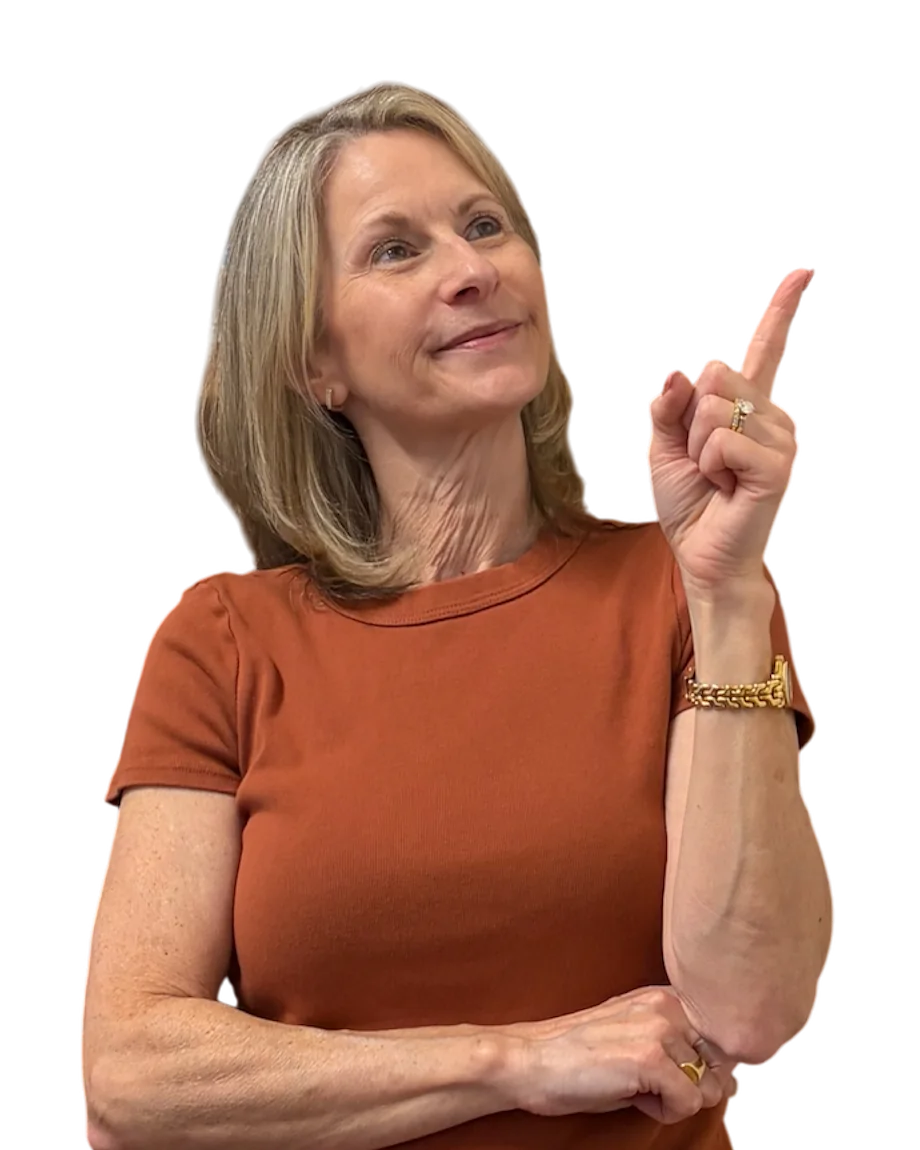 Dr. Janice Fedor smiling and pointing up toward the questions
